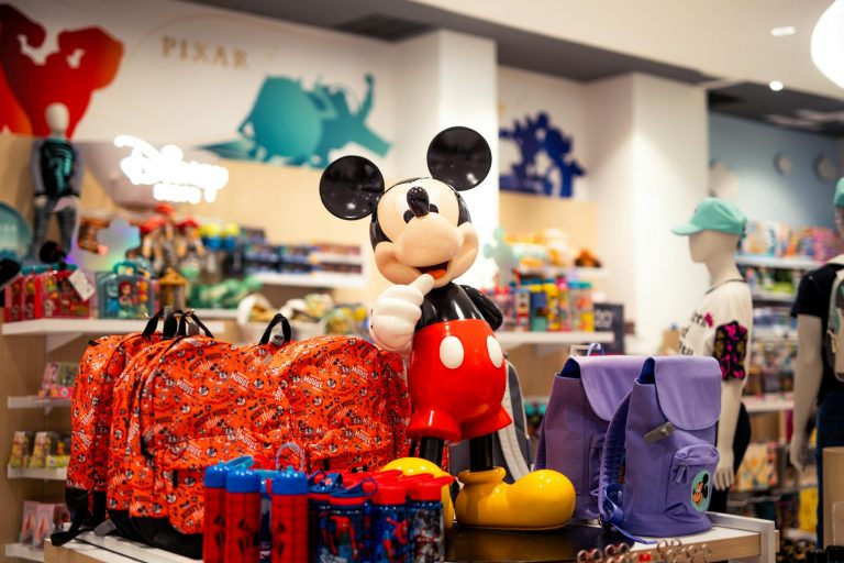 A vibrant retail display featuring Disney-themed merchandise with a prominent Mickey Mouse figure.